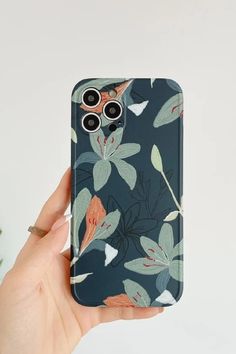 a person holding up a phone case with flowers on it