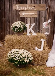 a hay bale with flowers and letters on it