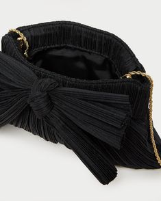 Pleated frame clutch in black organza fabric topped with our signature knotted bow. Features a removable twisted gold chain crossbody strap, frame closure, full lining, and gold stamped logo. Chic Bow Evening Bag For Party, Chic Party Evening Bag With Bow, Chic Evening Bags With Bow, Chic Evening Bag With Detachable Bow, Elegant Evening Bag With Bow, Chic Black Evening Bag For Gala, Chic Formal Evening Bag With Bow, Eyeglass Jewelry, Bow Clutch