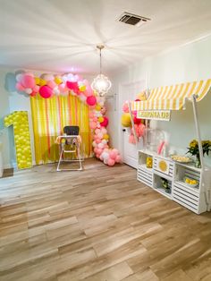 a room decorated with balloons and decorations