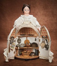 a doll is sitting in an old fashioned oven