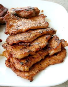 some meat is sitting on a white plate