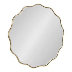 a round mirror with gold trimmings on the edges and an oval shaped frame