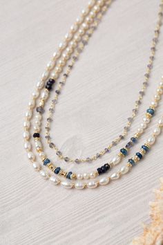 Beautiful white freshwater pearls are spaced with subtle gold filled beads and accented with kyanite and iolite. This classic, handmade multi strand necklace is stunning year round. Sterling Silver, Gold Filled Kyanite, Iolite, Fresh Water Pearls 17-19", adjustable with sterling silver lobster claw clasp We hand select our natural materials, thus there may be slight variations in color and/or size that will not detract from the overall aesthetic Our unique handcrafted designer jewelry for women Pearl Jewellery Designs, Fresh Water Pearl Necklace, Beading Inspiration, Pearl Jewelry Design, Pearl Necklace Designs, Designer Handmade Jewellery, Beading Ideas, Necklace Design, Fresh Water Pearls