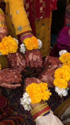 people with yellow and white flowers on their hands