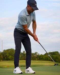 a man is playing golf on the green