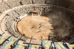 an aerial view of a circus with people in the ring and onlookers