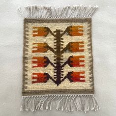 an old native american rug with fringes on the bottom and two different colored designs