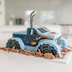 a cake made to look like a monster truck with flames coming out of the engine