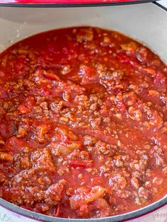 a large pot filled with chili sauce on top of a stove