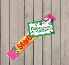 a candy bar sitting on top of a wooden fence