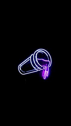 a neon sign on the side of a building with a microphone in it's ear