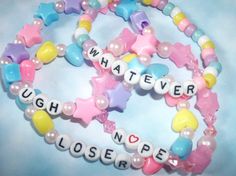 three bracelets with words written on them and beads in the shape of star shapes