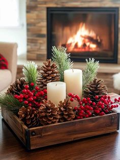 a wooden tray filled with pine cones and candles on top of a table next to a fire place