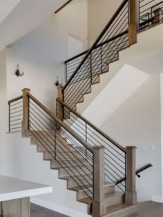 an empty room with a table and stairs