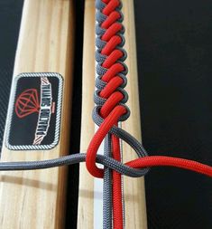 a close up of a surfboard with a red rope attached to the back end