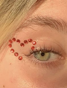 Gem Ideas For Face, Concert Jewel Makeup, Red Gemstone Eye Makeup, Cute Gem Makeup, Concert Face Jewels, Bedazzle Eye Makeup, Gems Around Eyes, Eras Tour Eye Gems, Red Gemstone Makeup