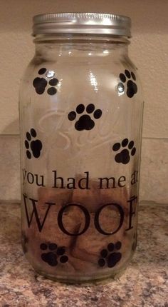 a glass jar that has some dog paw prints on it and the words you had me at woof