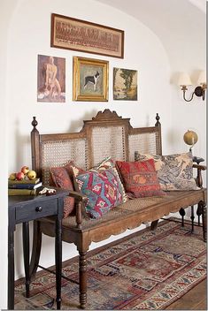 a living room filled with furniture and pictures on the wall