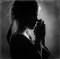 black and white photograph of a woman praying