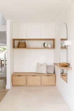 a room with white walls and wooden shelves