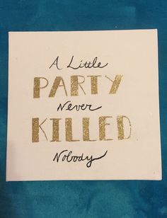 a little party never killed nobody written on a piece of white paper with gold foil