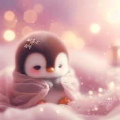 a small penguin with a pink scarf around it's neck