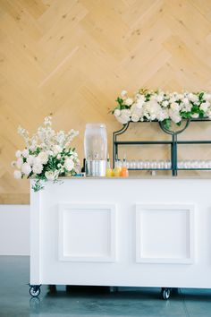 the bar is decorated with white flowers and candles