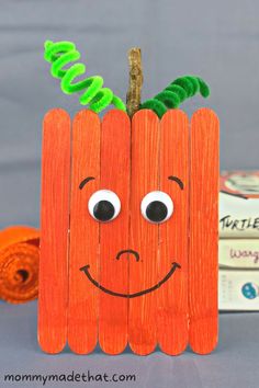 a carrot with eyes and nose made out of wood sticks