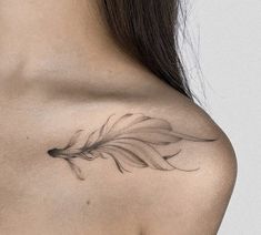 a woman with a feather tattoo on her shoulder