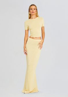 Upgrade your wardrobe in SER.O.YA's Kora Skirt. This chic mid-rise maxi skirt is crafted from a breathable knit fabric for ultimate comfort and style. Pair with the Clare Baby Tee for a co-ord look. Shown here in Butter. 39% Linen, 31% Cotton, 30% Nylon Made in China Model is 5'10" wearing size XS Style No. 3839-16 ABO Chic Spring Maxi Skirt For Loungewear, Chic Ribbed Maxi Skirt For Spring, Chic Summer Maxi Skirt For Loungewear, Chic Summer Loungewear Maxi Skirt, Spring Ribbed Skirt For Loungewear, Fitted Ribbed Maxi Skirt, Spring Ribbed Stretch Maxi Skirt, Fitted Ribbed Maxi Skirt For Spring, Spring Stretch Ribbed Maxi Skirt