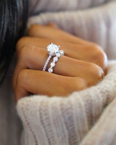 a woman's hand holding a diamond ring with the words brilliant earth above it