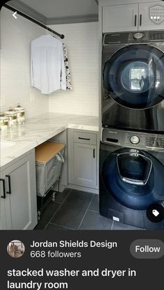 a washer and dryer in a room with tile flooring, white walls and cabinets