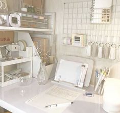 a white desk topped with lots of office supplies