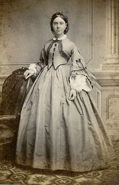 an old photo of a woman in a long dress