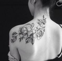 the back of a woman's shoulder with flowers on it