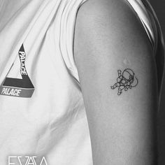 a person with a small tattoo on their left arm and the other arm behind him