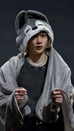 a young man wearing a gray animal costume