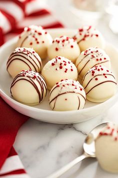 white chocolates with red sprinkles on a plate