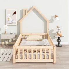 a wooden bed frame in the middle of a room with white walls and wood flooring