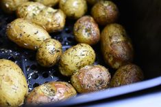 the potatoes are being cooked and seasoned in the slow cooker with oil on them