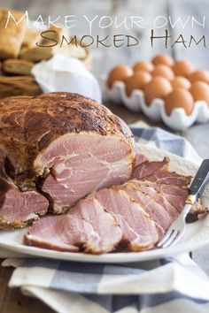 sliced ham on a plate with a knife and fork