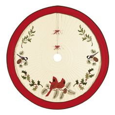 a red and white christmas tree skirt with birds on it