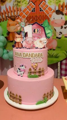 a pink cake with farm animals on it