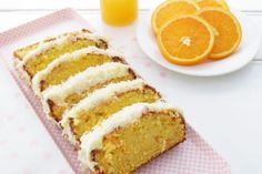 slices of orange cake sitting on top of a pink napkin next to an orange slice