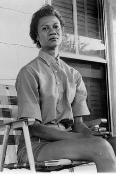 a black and white photo of a woman sitting in a chair