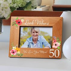 a wooden frame with an image of a woman's face and flowers on it