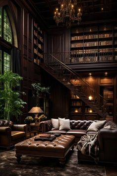 a living room filled with lots of furniture and bookshelves next to a stair case