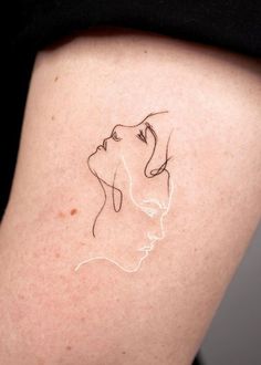 a woman's thigh with a line drawing of a dog on it