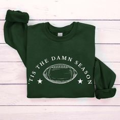 Football Sweatshirt and Hoodie, Tis The Damn Season Football Sweatshirt, College Football Game Day Shirt, College Football Sweater Hi!  Welcome to the Goshirtly! It's great to see you here! BLACK TEXT is used for  White, Light Pink, Ash, Sand Sweatshirts. Other colored shirts have white text. F I T ∙ & ∙ S I Z I N G : -->Women's sizes are narrower than the waist -->Sleeves are rolled up in some product pictures. They do not come rolled up on delivery. T I M E ∙ T O ∙ D E L I V E R Y : -->Process Green Tops For Fall Sports Events, Green Long Sleeve Sweatshirt For Game Day, Game Day Green Winter Sweatshirt, Green Sweatshirt For Game Day In Winter, Green Winter Sweatshirt For Game Day, Green Tops For Game Day In Winter, Green Crew Neck Hoodie For Sports Season, Tis The Damn Season, College Football Games